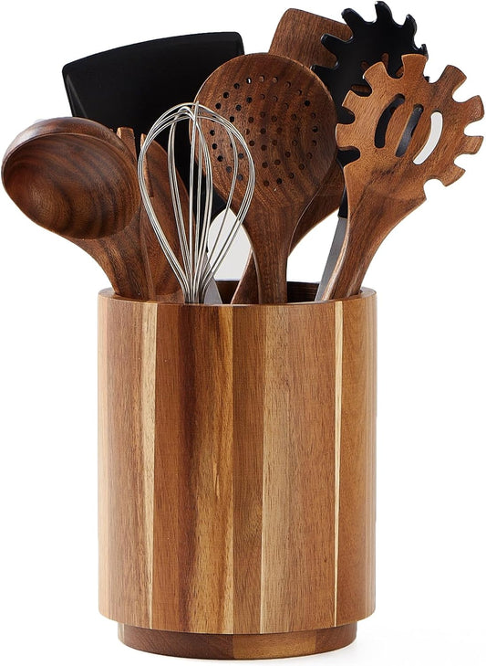 Wooden kitchen utensils in a wooden holder on a white background